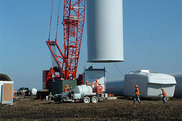 The turbine base being guided onto the foundation.