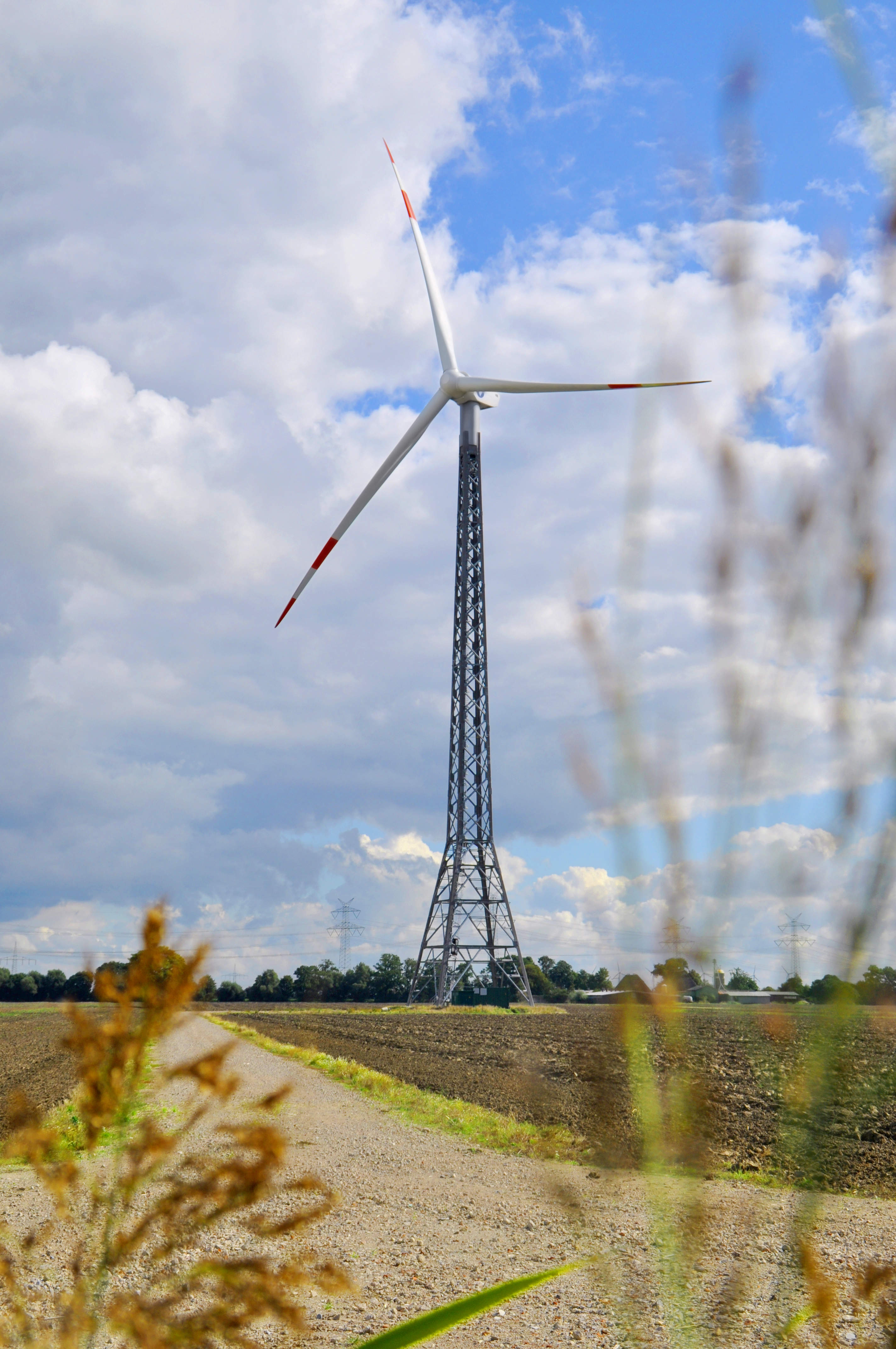 A wind turbine infront of a blue sky